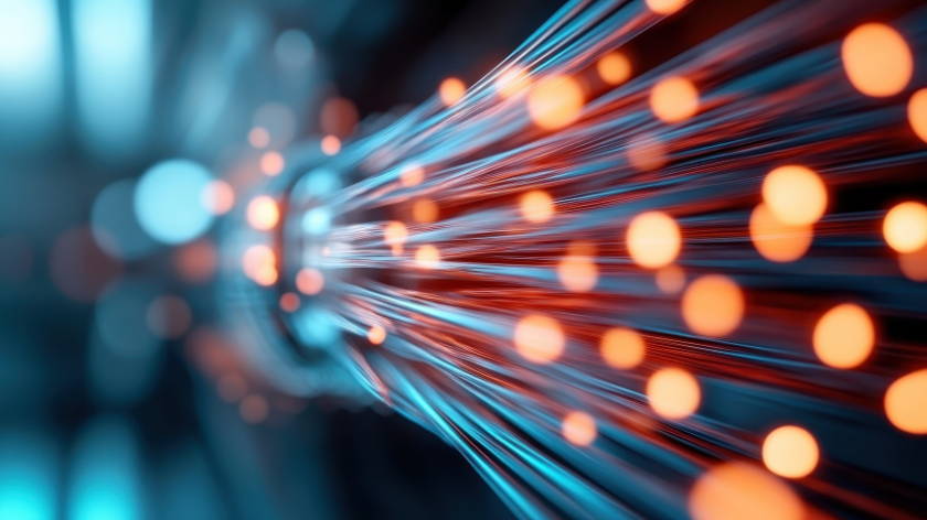 AI-generated abstract image of a dynamic stream of illuminated fiber optics cables in bright orange and blue, symbolizing high-speed data transmission and connectivity.